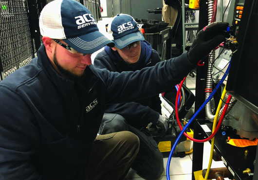 ACS Services, LLC’s four-year apprentice, Keith Faulkner (left), is helping train Nick Juliana, second-year apprentice. 